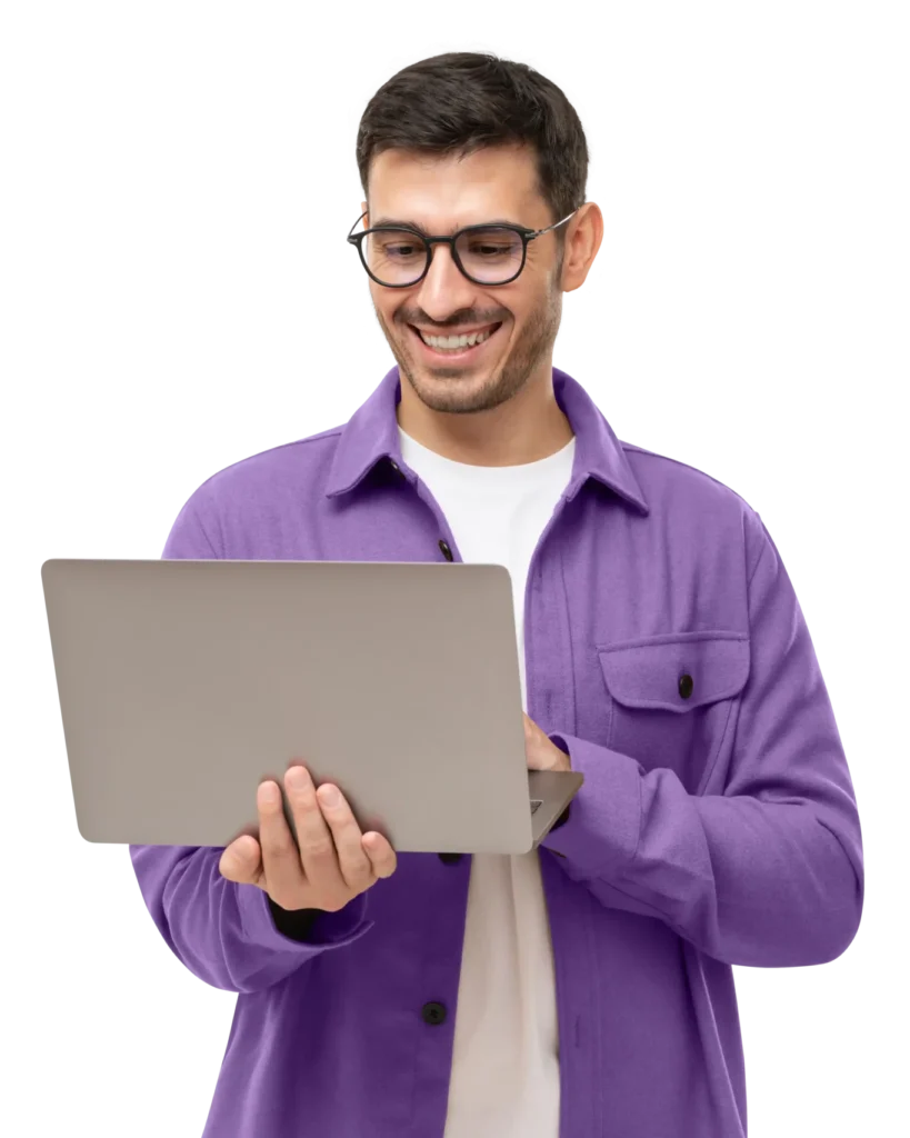 young man smiling with laptop in hand
